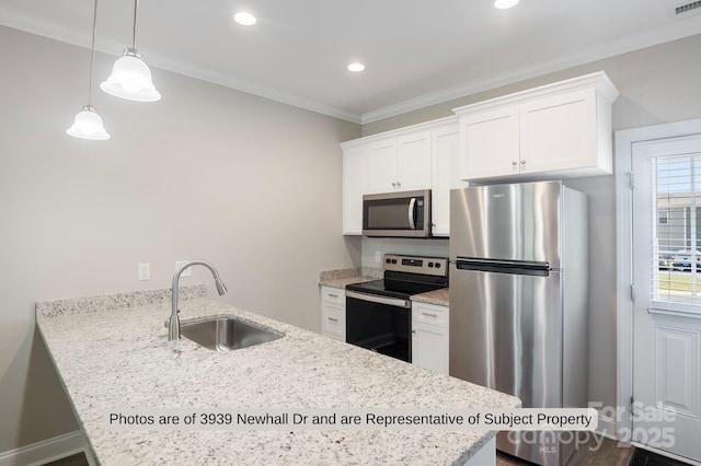 kitchen with stainless steel appliances, white cabinetry, and sink