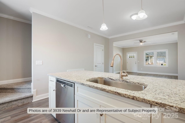 kitchen featuring light stone countertops, sink, hanging light fixtures, stainless steel dishwasher, and white cabinets