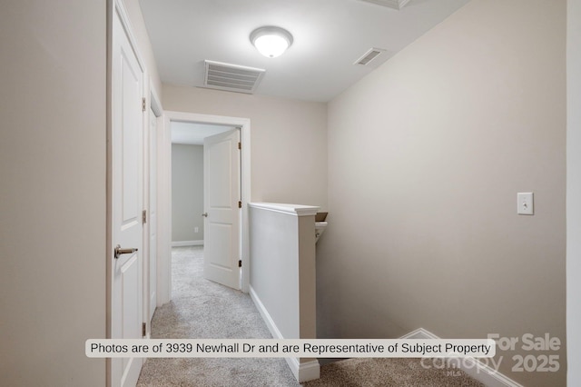 hallway with light colored carpet