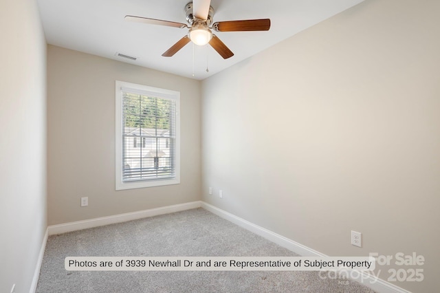 carpeted spare room featuring ceiling fan