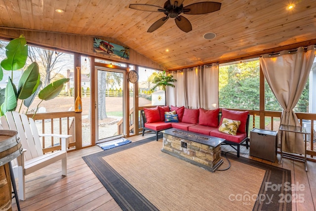 sunroom with ceiling fan, wood ceiling, and vaulted ceiling