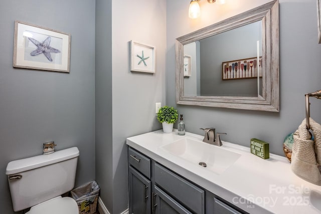 bathroom featuring vanity and toilet