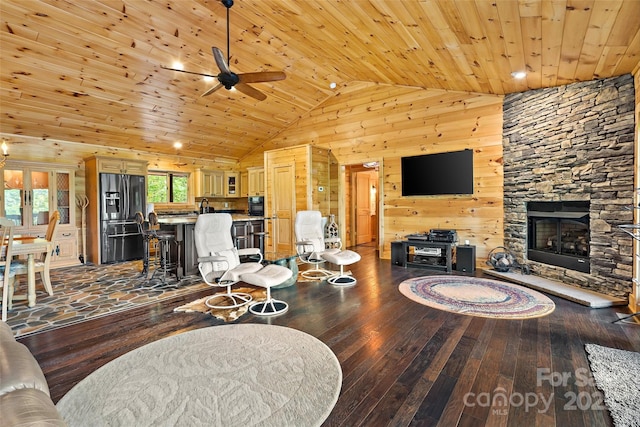 62 N Bear Cliff Dr, Nebo, NC 28761 - living room with wood walls, a stone fireplace, ceiling fan, wood ceiling, and hardwood / wood-style flooring