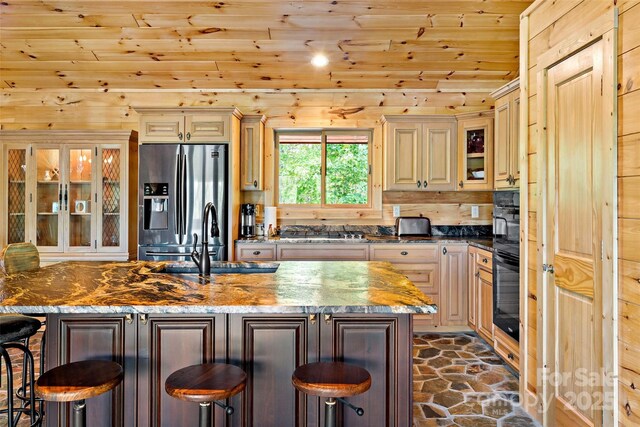 62 N Bear Cliff Dr, Nebo, NC 28761 - kitchen featuring wood ceiling, a kitchen breakfast bar, stone flooring, a sink, and stainless steel appliances