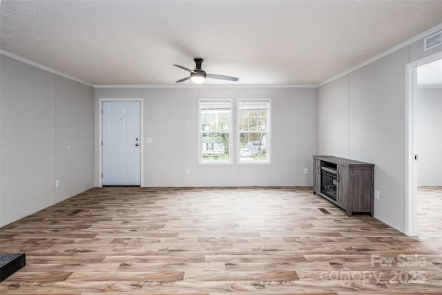 unfurnished living room with ceiling fan, light hardwood / wood-style floors, and ornamental molding