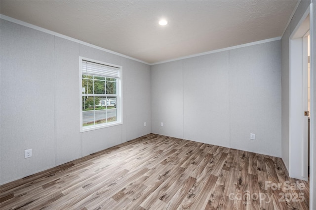 unfurnished room with crown molding and light hardwood / wood-style floors