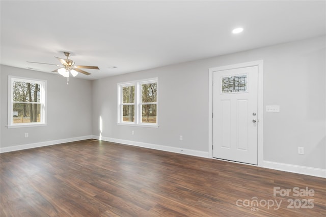 interior space with dark wood-type flooring, ceiling fan, and a wealth of natural light