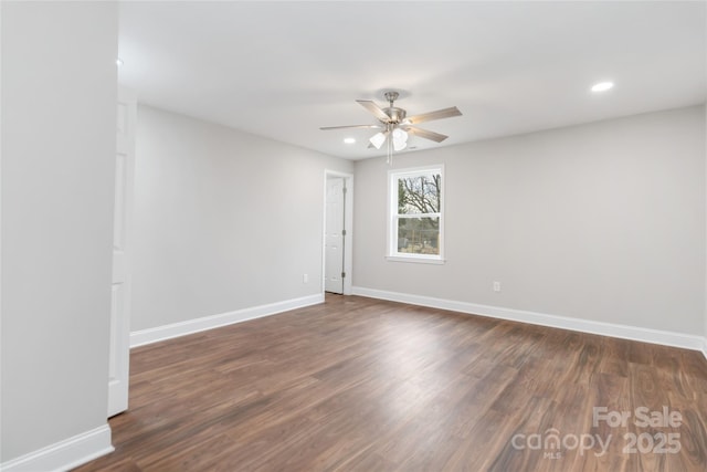 empty room featuring dark hardwood / wood-style flooring and ceiling fan