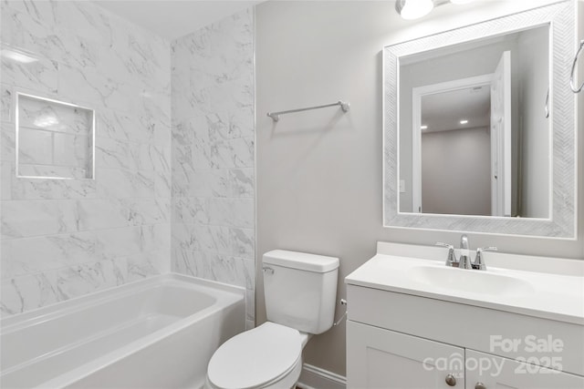 full bathroom featuring tiled shower / bath, vanity, and toilet