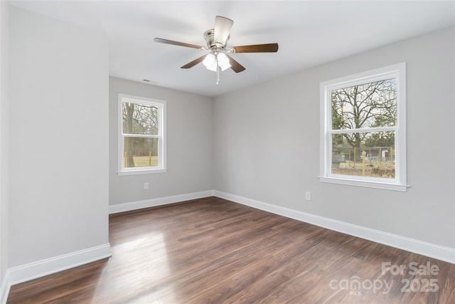 empty room featuring ceiling fan and dark hardwood / wood-style flooring