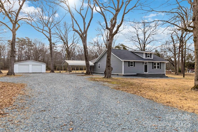 view of side of property with a garage, an outdoor structure, and a carport