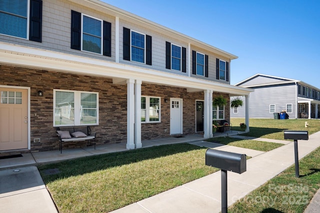 view of front of house featuring a porch and a front lawn