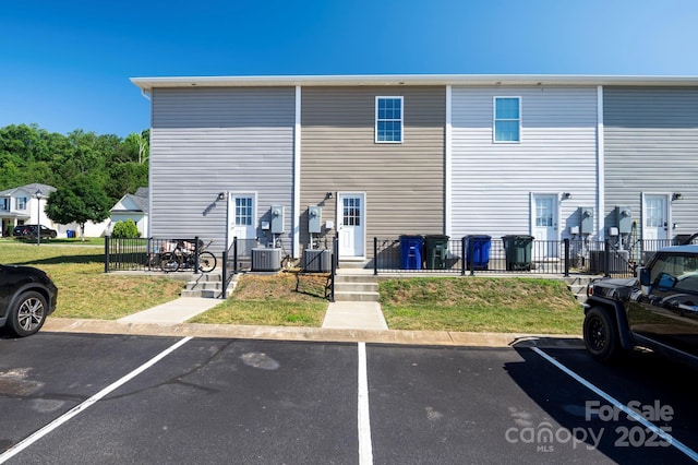 rear view of house featuring central AC unit