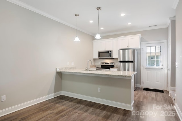 kitchen with kitchen peninsula, sink, white cabinets, and appliances with stainless steel finishes