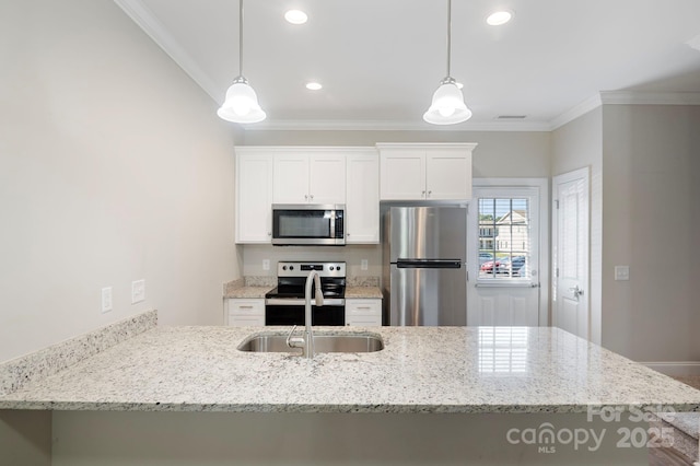 kitchen with white cabinets, hanging light fixtures, sink, and appliances with stainless steel finishes