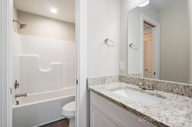 full bathroom with toilet, vanity, hardwood / wood-style floors, and tub / shower combination