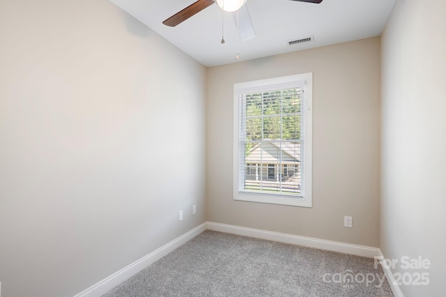 carpeted empty room featuring ceiling fan