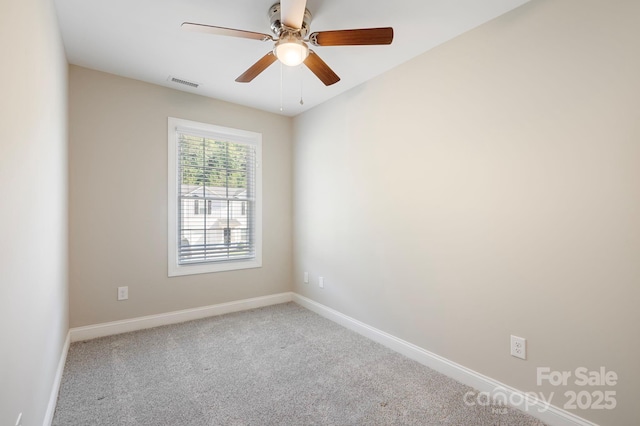 spare room featuring carpet flooring and ceiling fan