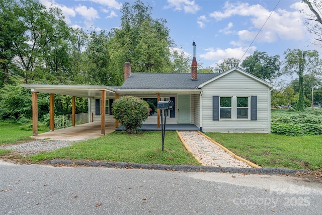 single story home featuring a carport, a porch, and a front yard