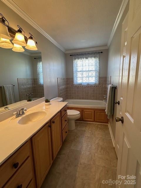 bathroom featuring toilet, vanity, ornamental molding, and a bath