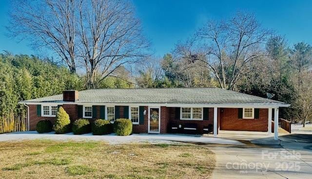 ranch-style home with a front lawn