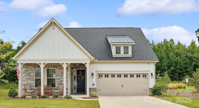 view of front of property with covered porch, a front yard, and a garage