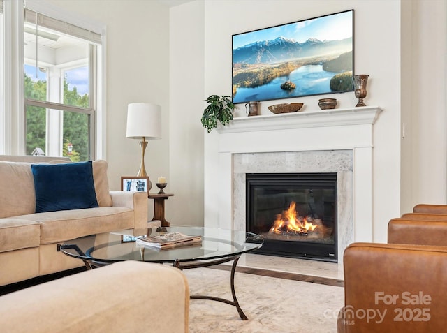 sitting room with a fireplace and light hardwood / wood-style floors