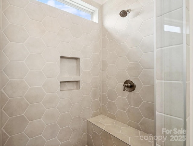 bathroom with tiled shower