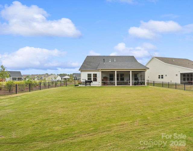 back of house featuring a sunroom and a yard