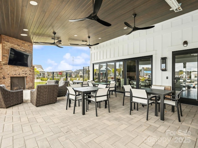 view of patio / terrace with an outdoor living space with a fireplace