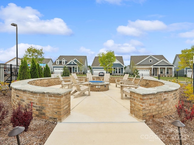 view of home's community featuring a fire pit and a patio