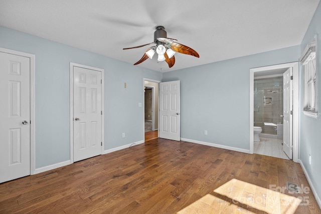 unfurnished bedroom featuring hardwood / wood-style flooring, ceiling fan, and connected bathroom