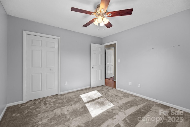 unfurnished bedroom with ceiling fan, a closet, and light colored carpet