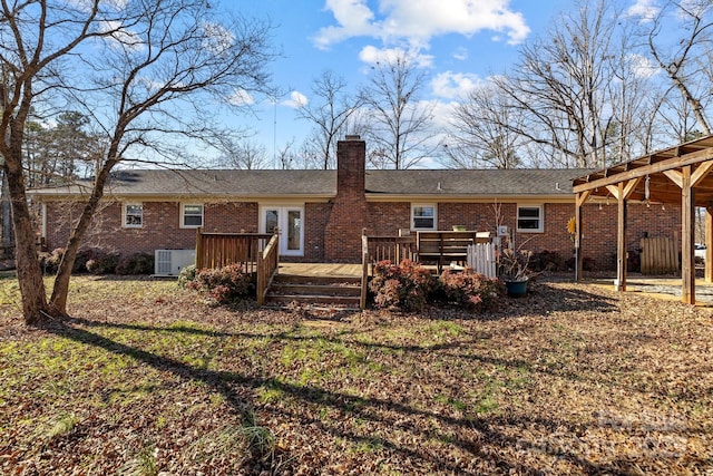 back of house featuring a wooden deck and central AC