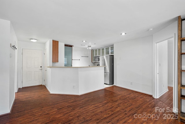 unfurnished living room with dark wood-type flooring