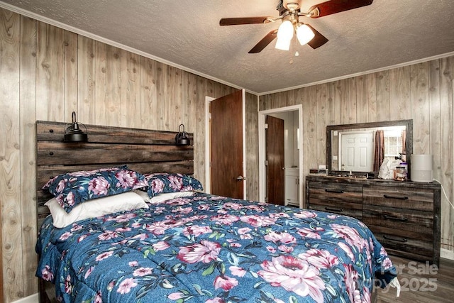 bedroom featuring crown molding, wooden walls, a ceiling fan, and a textured ceiling