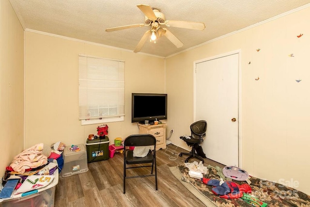 rec room featuring crown molding, wood finished floors, and a textured ceiling