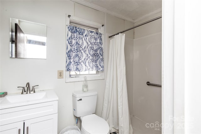 bathroom with vanity, toilet, a shower with curtain, and a wealth of natural light