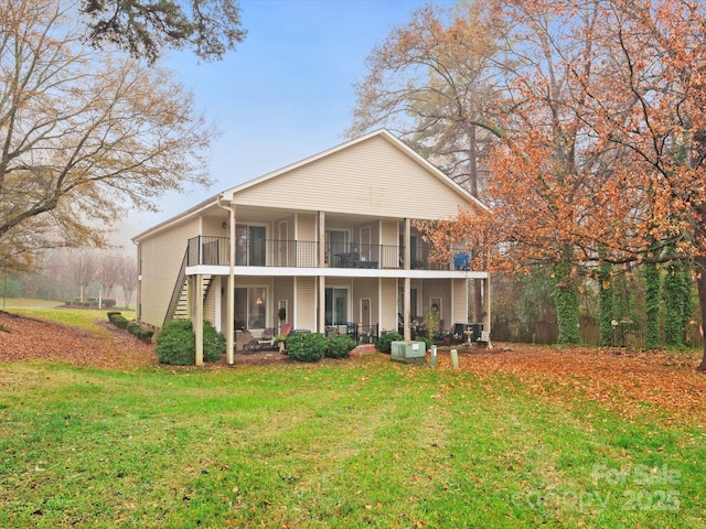 1985 Lancer Ct, Gastonia, NC 28054 - back of house featuring a lawn, a balcony, and stairs