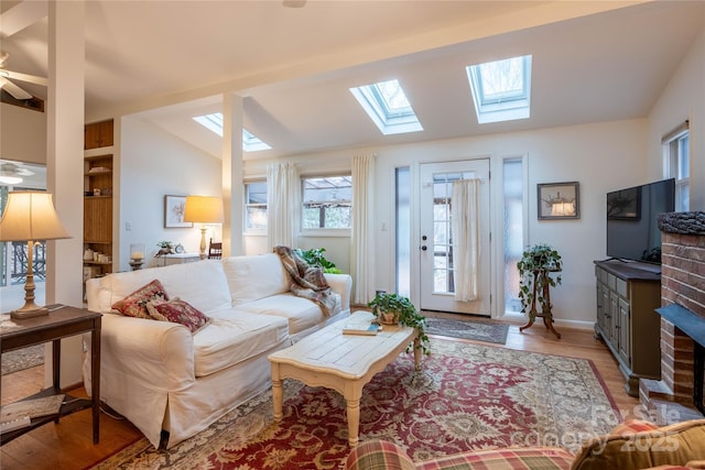 living room featuring vaulted ceiling, ceiling fan, and light hardwood / wood-style flooring