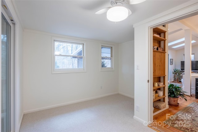 carpeted spare room with ceiling fan