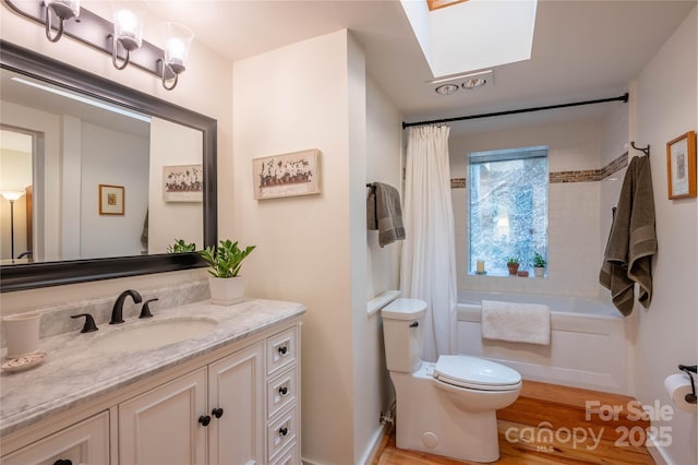 full bathroom featuring shower / tub combo with curtain, vanity, hardwood / wood-style flooring, and toilet