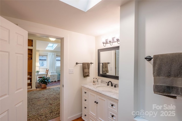 bathroom featuring vanity and a skylight