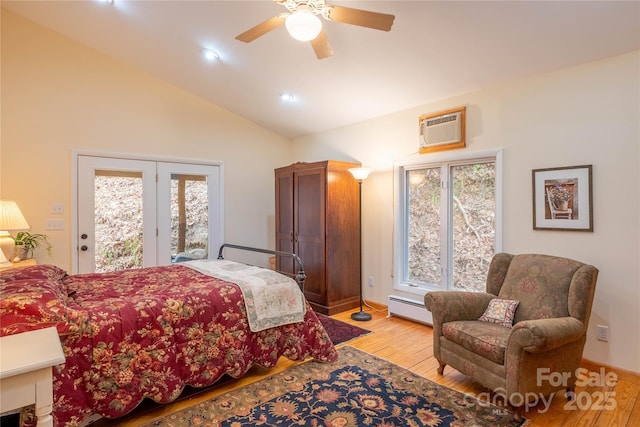 bedroom with light hardwood / wood-style flooring, ceiling fan, baseboard heating, a wall unit AC, and access to outside