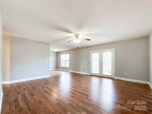 unfurnished room featuring french doors, ceiling fan, and hardwood / wood-style flooring