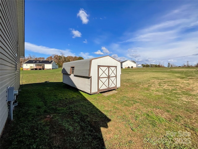 view of outbuilding featuring a yard