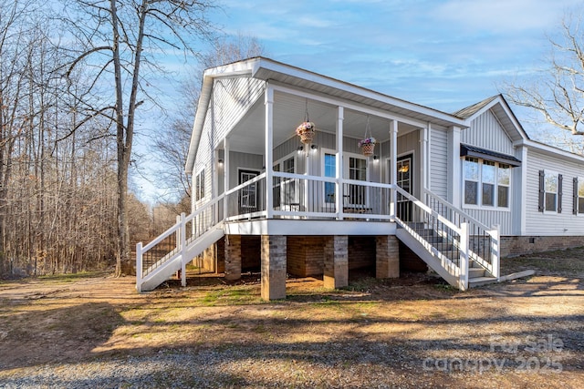 back of house featuring covered porch