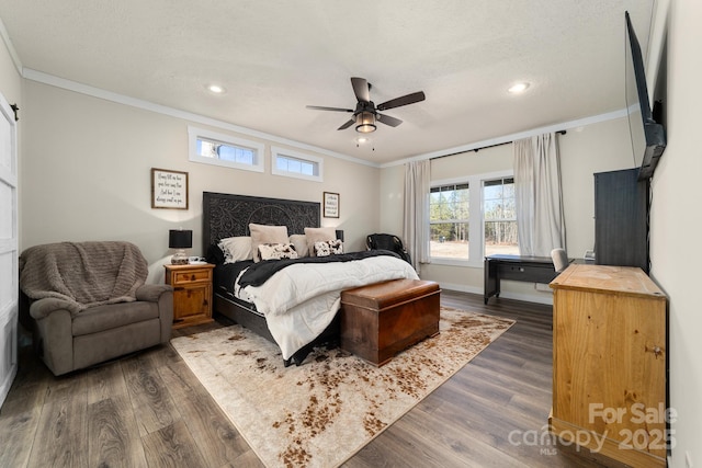 bedroom featuring dark wood-type flooring, a textured ceiling, ceiling fan, and crown molding