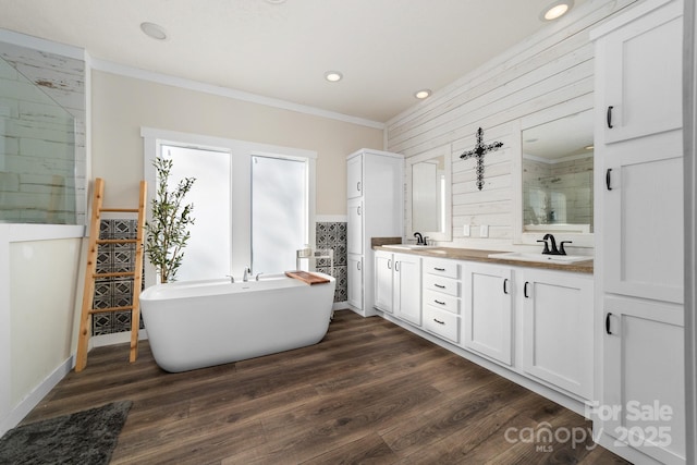 bathroom featuring ornamental molding, plus walk in shower, vanity, and hardwood / wood-style flooring