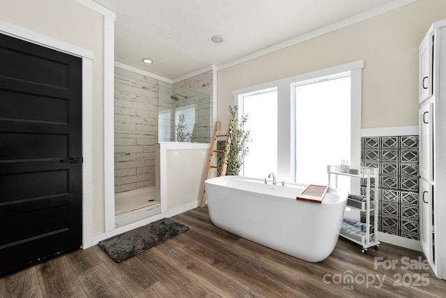 bathroom featuring tile walls, ornamental molding, independent shower and bath, and hardwood / wood-style floors